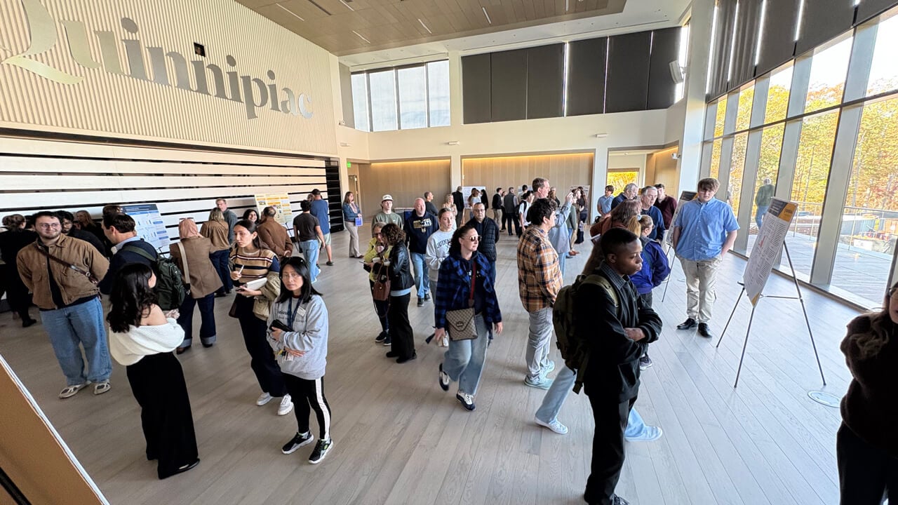 A large crowd wandering around the poster session