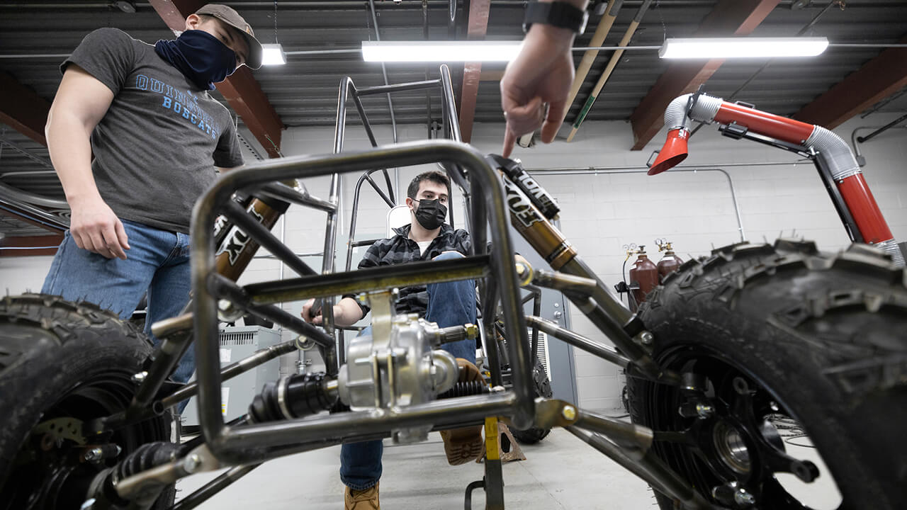 Students discuss the car they are building