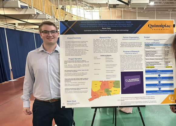 Kevin Clark posing with his poster