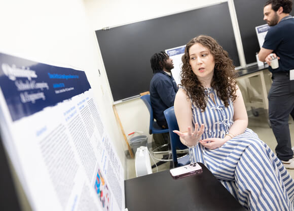 Student presenting her project poster at Projects Day