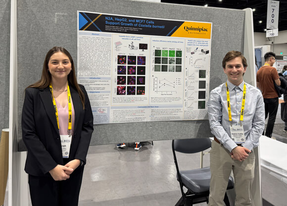 Two students present poster