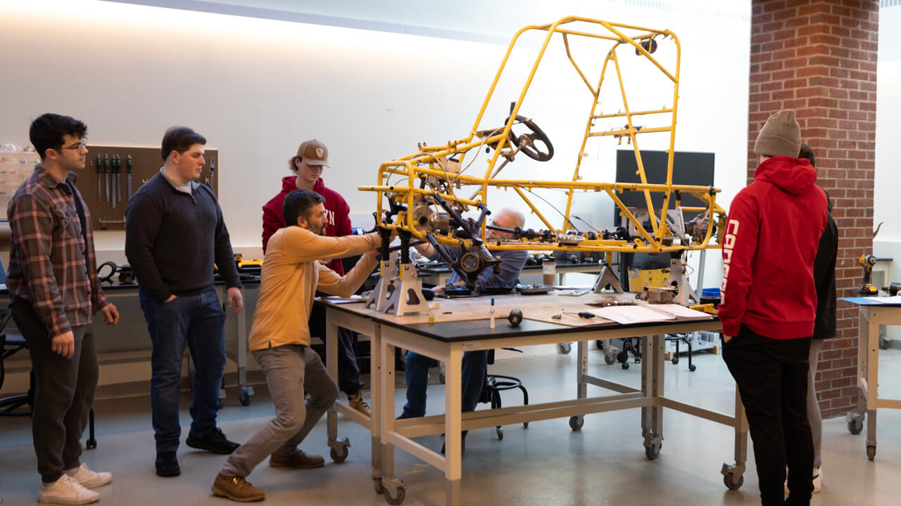 The Baja team examining the vehicle